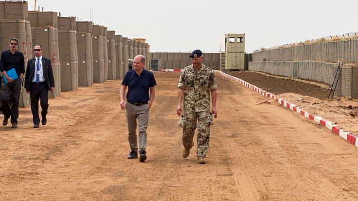 German Chancellor Olaf Scholz inspects the base of the German armed forces in Tillia, Niger May 23, 2022. 