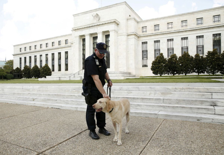 A police officer patrols with his dog at the Federal Reservein Washington September 1, 2015.  