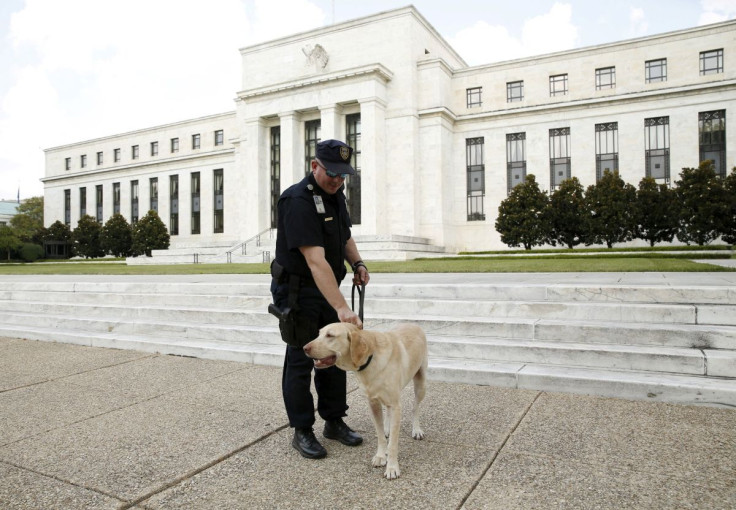 A police officer patrols with his dog at the Federal Reservein Washington September 1, 2015.
