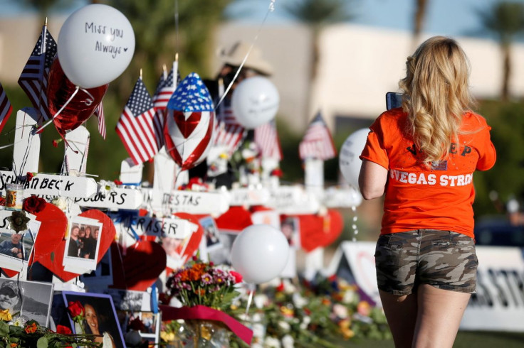 A woman looks at white crosses set up for the victims of the Route 91 Harvest music festival mass shooting in Las Vegas, Nevada, U.S., October 7, 2017. 