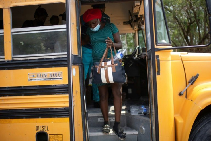 A pregnant Haitian woman gets off a bus bringing migrants to a US border entry point in Reynosa in northern Mexico