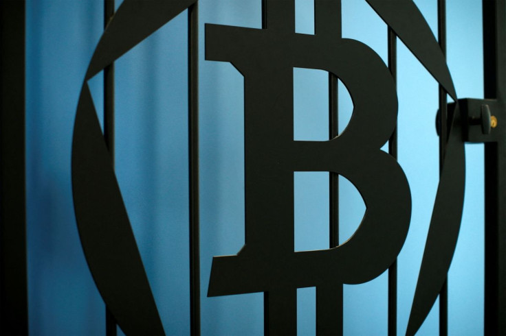 The logo of bitcoin is pictured on a door in an illustration picture taken at La Maison du Bitcoin in Paris July 11, 2014.    