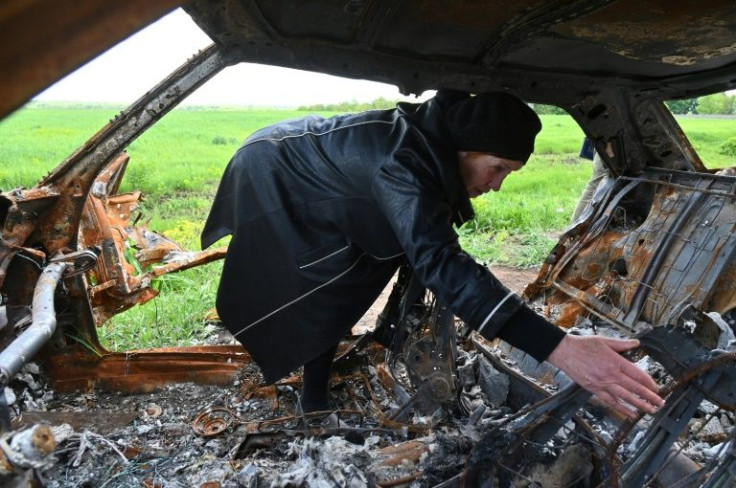 Olga Khomenko, 67, looks for the remains of her son, allegedly killed when a Russian tank shell hit his car outside a village near Kharkiv