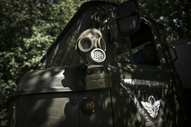 Ukrainian soldiers often carry gas masks because of the risk of fighting in an industrial region filled with oil refineries and chemical plants