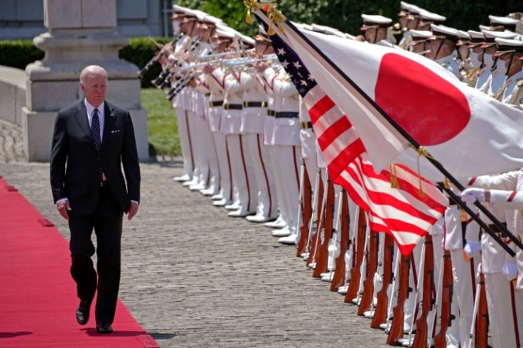 US President Joe Biden reviews an honour guard during a welcome ceremony at the Akasaka Palace in Tokyo