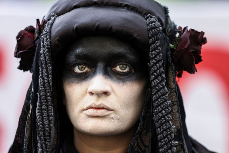 A climate activist attends a protest outside Shell headquarters during the company's first investor meeting since moving to the UK, in London, Britain, May 24, 2022.