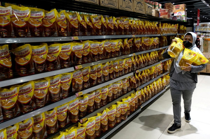 A woman shops for cooking oil made from oil palms at a supermarket in Jakarta, Indonesia, March 27, 2022. 