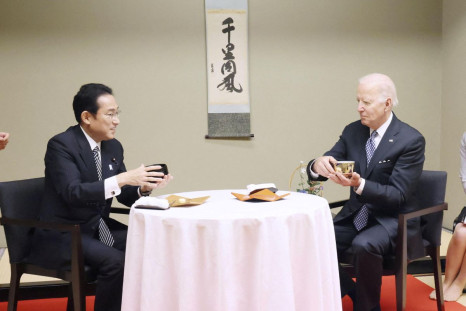 U.S. President Joe Biden experiences a traditional tea ceremony with Japan's Prime Minister Fumio Kishida during a private dinner in Tokyo, Japan May 23, 2022, in this photo released by Japan's Cabinet Public Relations Office via Kyodo.  Japan's Cabinet P