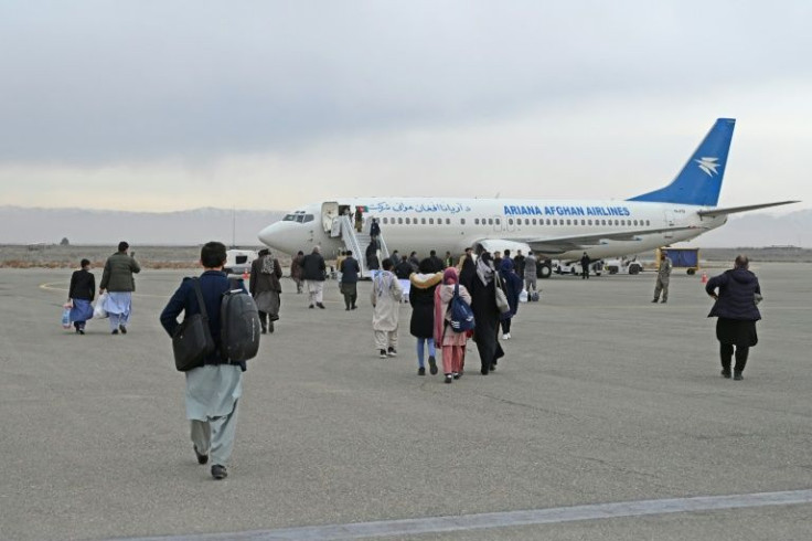 Afghan passengers board a commercial aircraft in February at Herat airport for a flight to Kabul