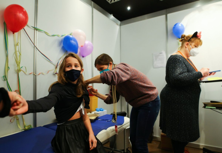 Eleven-year-old Chiara receives a dose of the Pfizer-BioNTech vaccine for children against the coronavirus disease (COVID-19) during a vaccination event for children at the Lanxess Arena in Cologne, Germany, December 18, 2021.