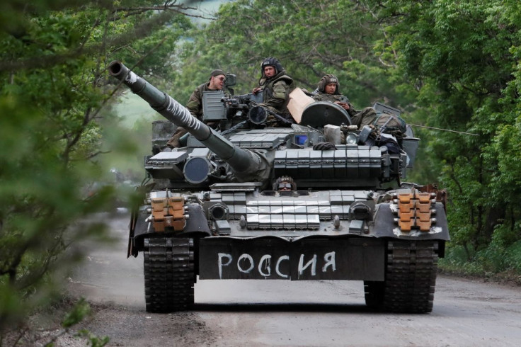 Service members of pro-Russian troops drive a tank during Ukraine-Russia conflict in the Donetsk Region, Ukraine May 22, 2022. The writing on the tank reads: "Russia". 