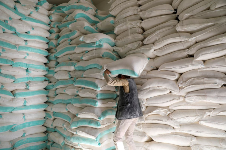 A worker carries a sack of wheat flour at a World Food Programme food aid distribution center in Sanaa, Yemen February 11, 2020. 