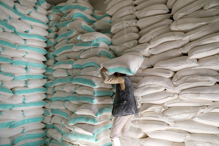 A worker carries a sack of wheat flour at a World Food Programme food aid distribution center in Sanaa, Yemen February 11, 2020.