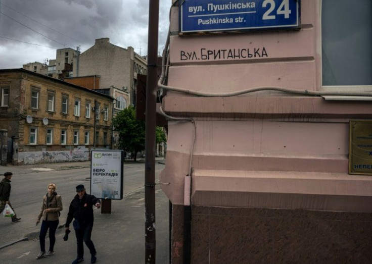 Ukrainian street artist Gamlet has written 'British Street' underneath several of the name plaques