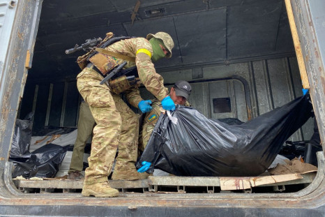Ukrainian servicemen load bodies of killed Russian soldiers to a refrigerated rail car, as Russia's attack on Ukraine continues, at a compound of a morgue in Kharkiv, Ukraine May 22, 2022.  