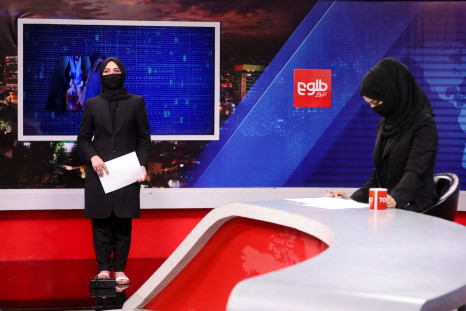 Female presenters for Tolo News, Sonia Niazi and Khatereh Ahmadi, while covering their face, work in a newsroom at Tolo TV station in Kabul, Afghanistan, May 22, 2022. 