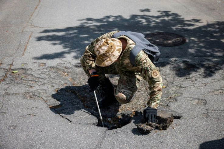 A bomb squad member searches for unexploded devices in Gorky Park