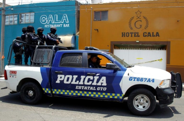 Police patrol outside a bar and hotel in the Mexican city of Celaya where 11 people were killed in an apparent gangland attack