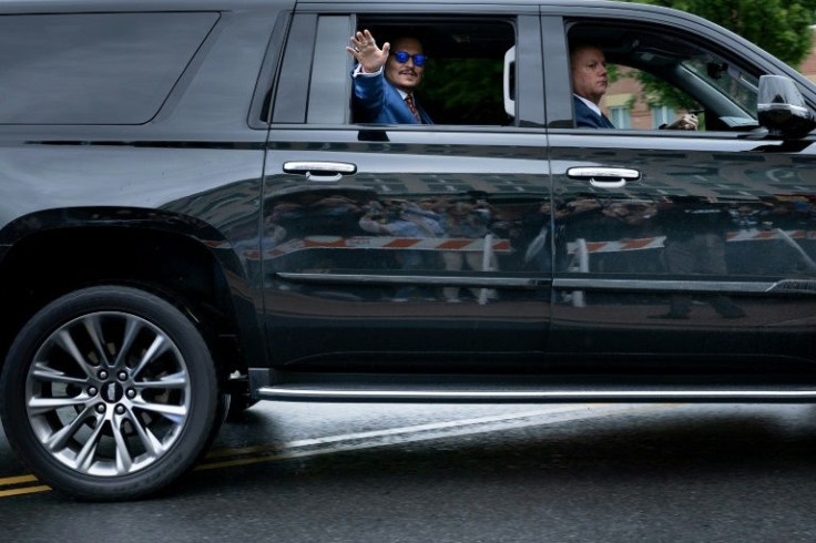 Johnny Depp arrives at court, waving to his loyal supporters