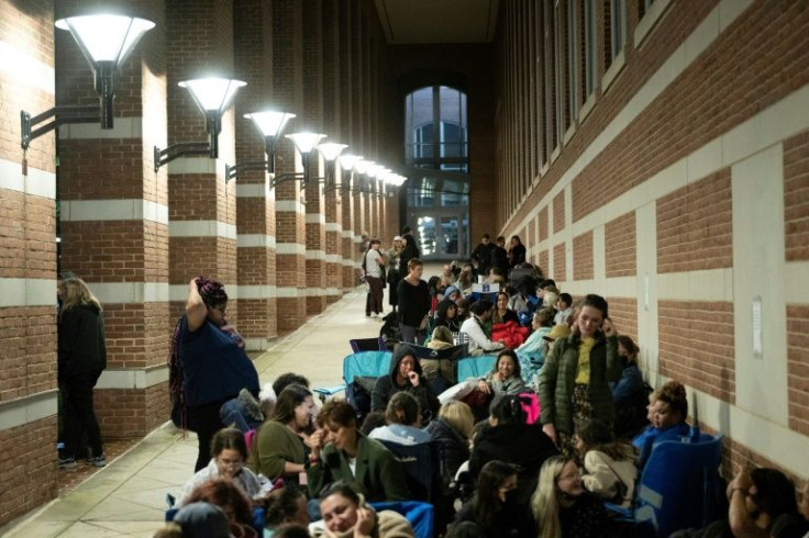 People take their place in line at 1:00 am in an effort to get courtroom access during the final week of the Depp vs Heard defamation trial at Fairfax County Court, Virginia