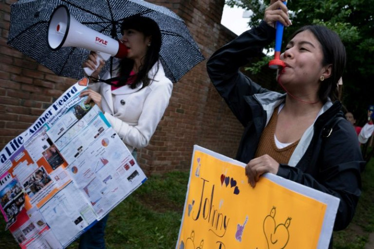 Christina Taft, of Los Angeles, voices support for Amber Heard while standing with a fan of Johnny Depp
