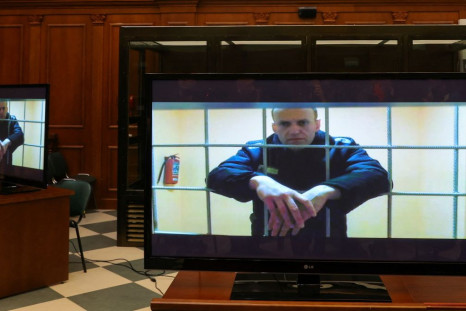 Russian opposition leader Alexei Navalny is seen on screens via a video link from the IK-2 corrective penal colony in Pokrov during a court hearing to consider an appeal against his prison sentence in Moscow, Russia May 24, 2022. 