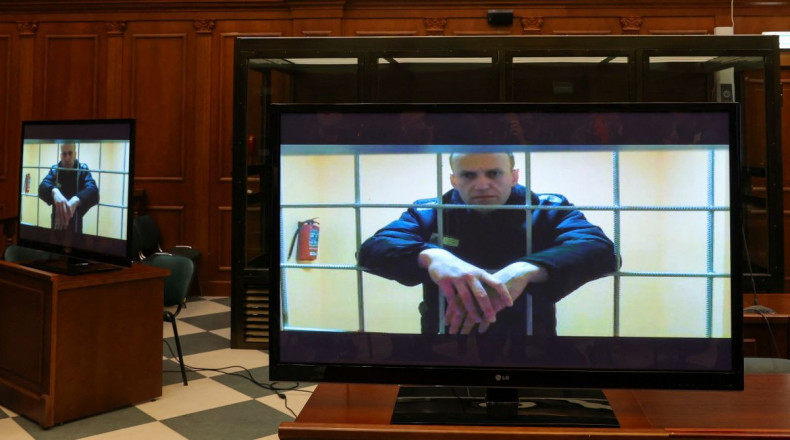 Russian opposition leader Alexei Navalny is seen on screens via a video link from the IK-2 corrective penal colony in Pokrov during a court hearing to consider an appeal against his prison sentence in Moscow, Russia May 24, 2022. 