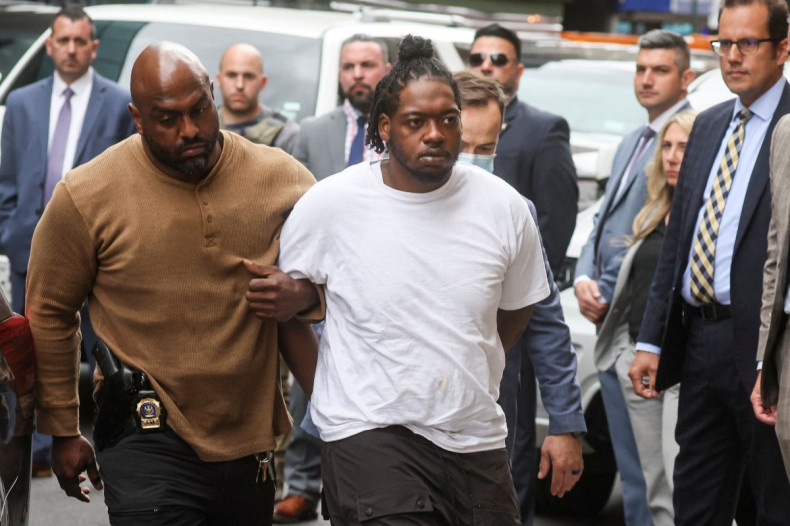New York Subway shooting suspect Andrew Abdullah is escorted by New York City Police (NYPD) Detectives as he arrives to turn himself in at a Police Precinct in New York City, U.S., May 24, 2022.  