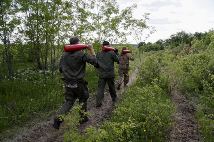 Service members of pro-Russian troops carry leaflet shells at their combat positions in the Luhansk region, Ukraine May 24, 2022. 