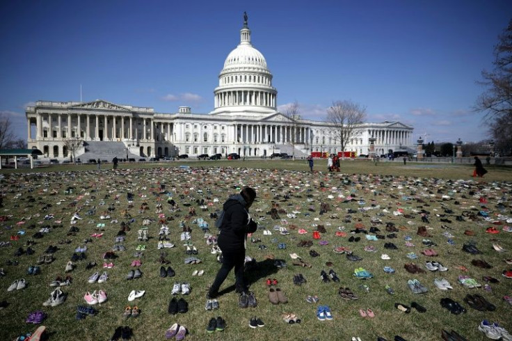 Activists spread 7,000 pairs of shoes, representing the children killed by gun violence since the mass shooting at Sandy Hook Elementary School in 2012, on the lawn on the east side of the US Capitol in March 2018