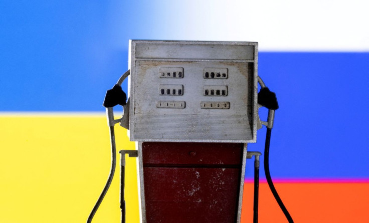 Model of petrol pump is seen in front of Ukraine and Russian flag colors in this illustration taken March 25, 2022. 