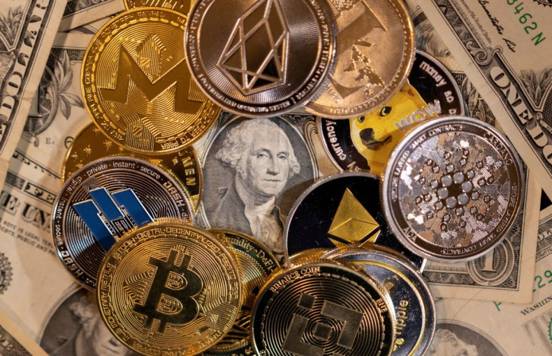 Representations of virtual cryptocurrencies are placed on U.S. Dollar banknotes in this illustration taken November 28, 2021. 
