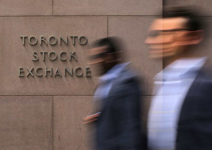 Businessmen pass the Toronto Stock Exchange sing in Toronto, Ontario, Canada July 6, 2017.