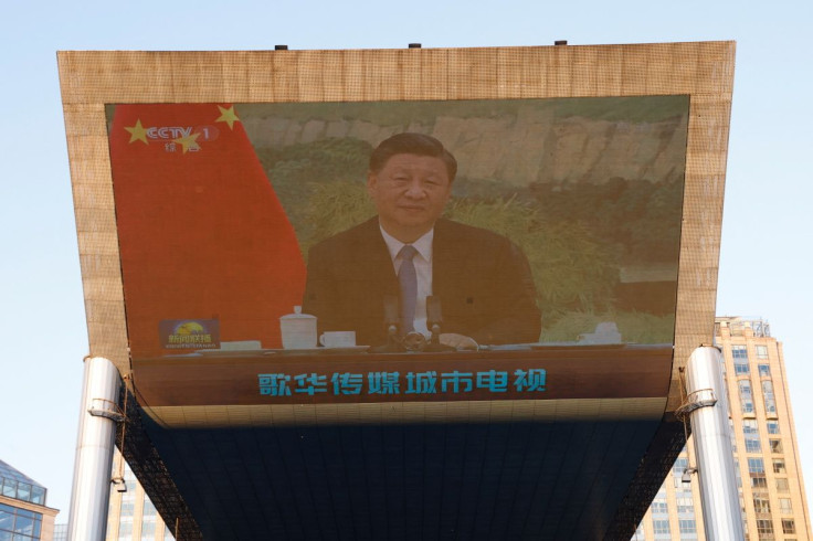 Chinese President Xi Jinping is seen on a giant screen, broadcasting news footage of his virtual meeting with United Nations High Commissioner for Human Rights Michelle Bachelet, at a shopping complex in Beijing, China May 25, 2022. 