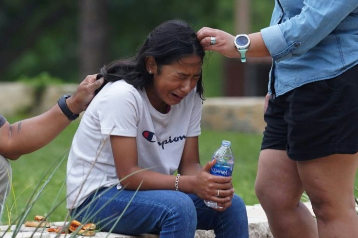 A girl cries outside the Willie de Leon Civic Center in Uvalde, Texas after a gunman killed 19 small kids and two teachers at an elementary school