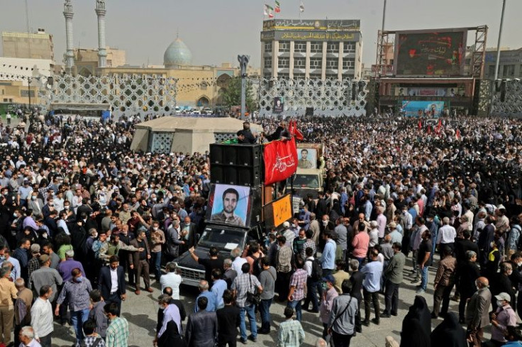 Mourners gather around the coffin of Iranian Revolutionary Guards colonel Sayyad Khodai at Imam Hussein Square in the capital Tehran after he was assassinated by assailants on motorcycles