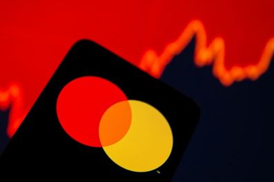 Smartphone with Mastercard logo is seen in front of displayed stock graph in this illustration taken, July 15, 2021. 