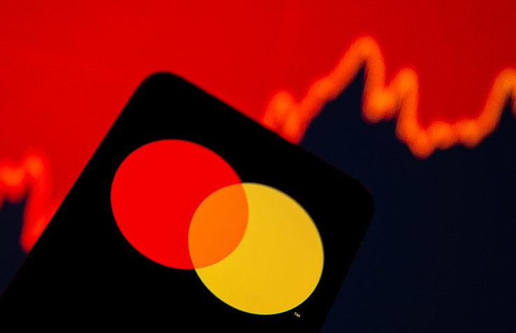 Smartphone with Mastercard logo is seen in front of displayed stock graph in this illustration taken, July 15, 2021. 