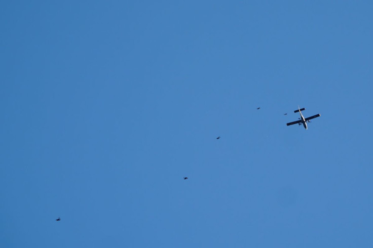 A military aircraft is seen from the baseball stadium Nationals Park during a performance by the parachute team the Golden Knights, in Washington, U.S., April 20, 2022, in this picture obtained from social media. @dcgrasstracker/via REUTERS 