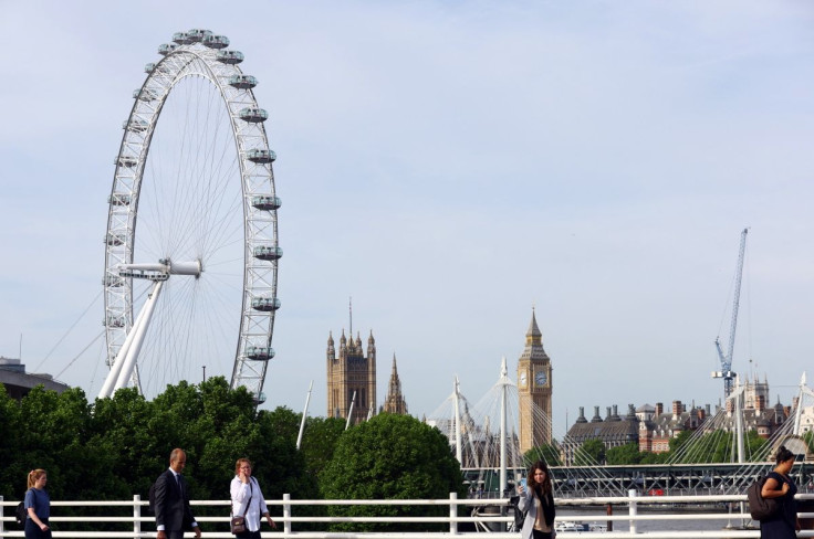 People walk across Waterloo Bridge during the morning rush hour in London, Britain, May 18, 2022. 