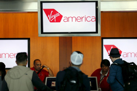 Passengers check in for their flights at the Virgin America ticket counter in San Diego, California April 4, 2016.  