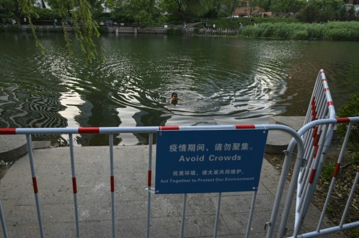A man swims in the Liangma River in Beijing