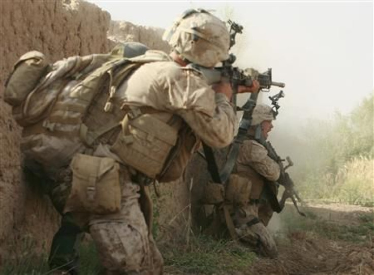 U.S. Marines from Lima Company 3rd Battalion, 6th Marines return fire during a shootout with Taliban fighters in Karez-e-Sayyidi, in the outskirts of Marjah district