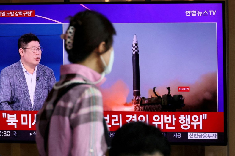 A woman watches a TV broadcasting a news report on North Korea's launch of three missiles including one thought to be an intercontinental ballistic missile (ICBM), in Seoul, South Korea, May 25, 2022.   