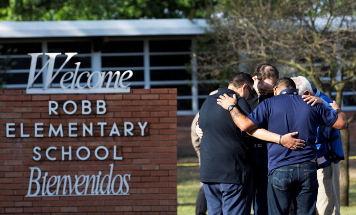 People gather at Robb Elementary School , the scene of a mass shooting in Uvalde, Texas, U.S. May 25, 2022. 