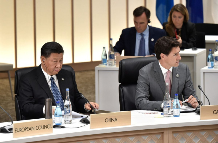 China's President Xi Jinping (L) and Canada's Prime Minister Justin Trudeau attend the session on women's workforce participation, future of work, and ageing societies, at the G20 Summit in Osaka, Japan,  June 29, 2019. Kazuhiro Nogi/Pool via 