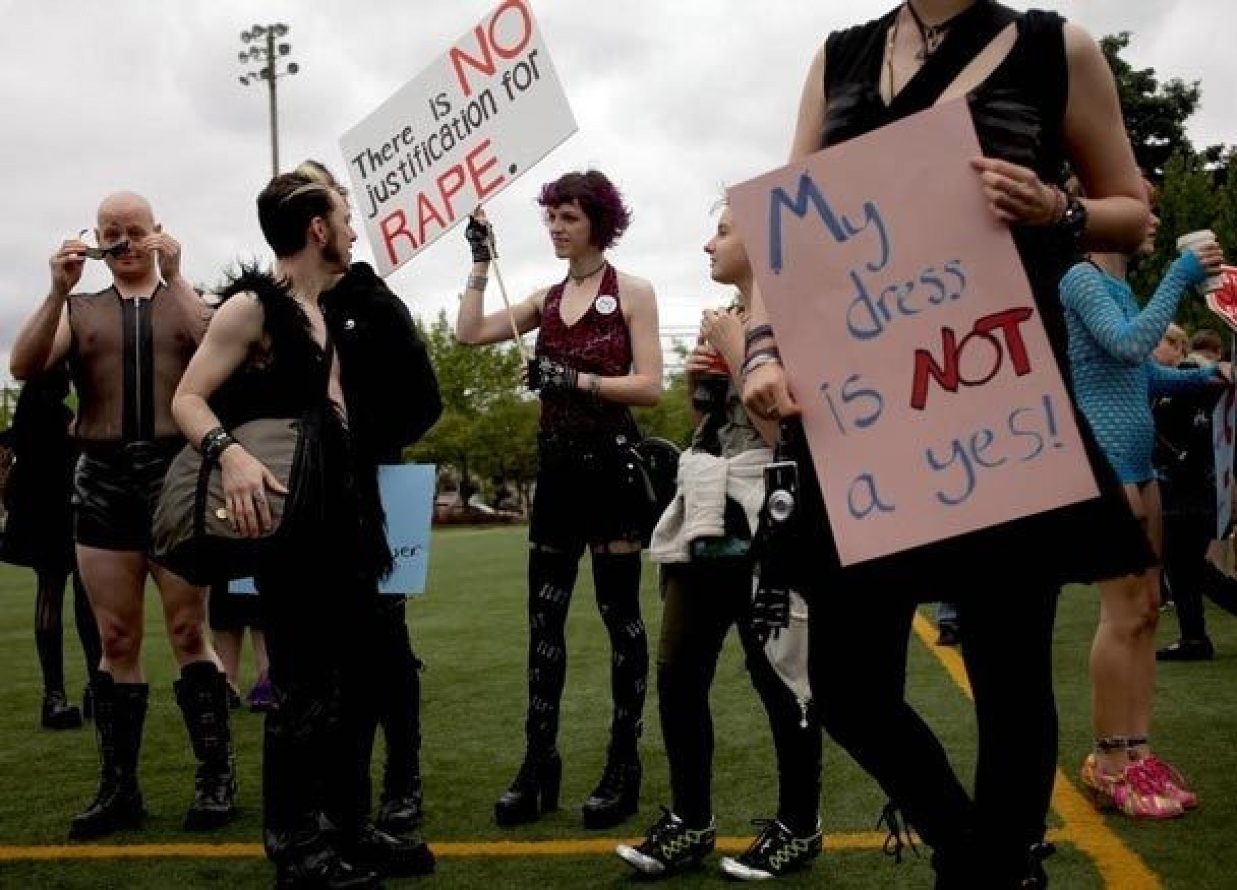 Jessica Drenkel, center with sign, talks with a group before participating in SlutWalk. 