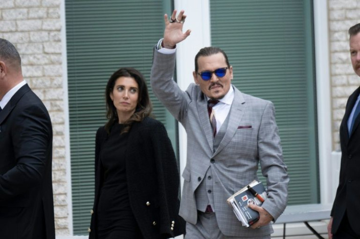 Johnny Depp waves to fans outside the Fairfax County Circuit Court