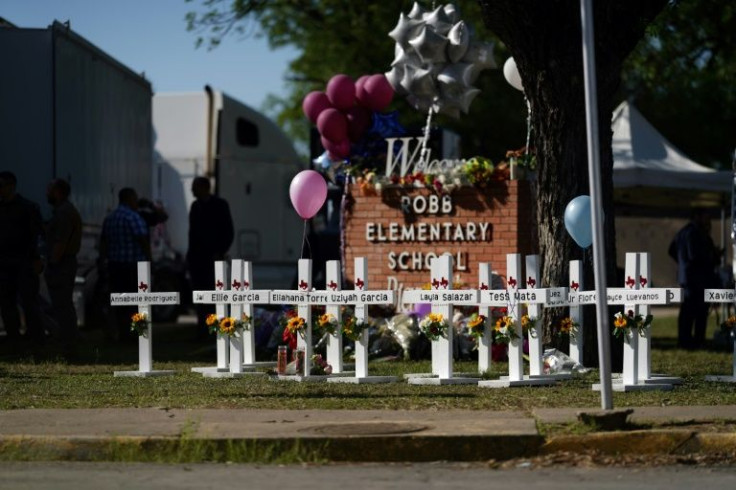 Crosses sit outside the Robb Elementary School in remembrance of those killed in the school shooting in Uvalde, Texas