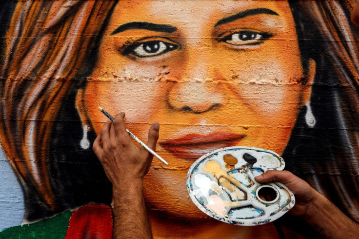 Artist Jaber Abbas, 35 years old, applies final touches to a mural that he painted to pay tribute to Al Jazeera journalist, Shireen Abu Akleh, who was shot dead during an Israeli military raid in the occupied West Bank, in Nazareth, Israel May 16, 2022.